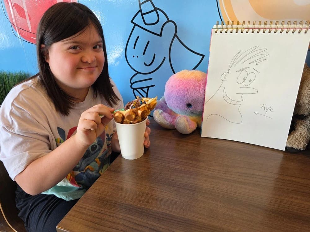 Child enjoying a bubble waffle treat at Fresh Cup